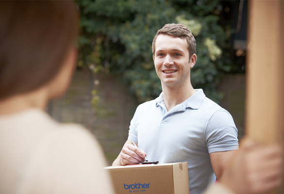 Man delivering a Brother box to woman opening the door