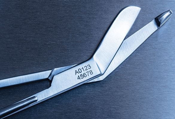 Stainless steel medical scissors etched with a tracking number using Brother stencil tape and electrochemical equipment