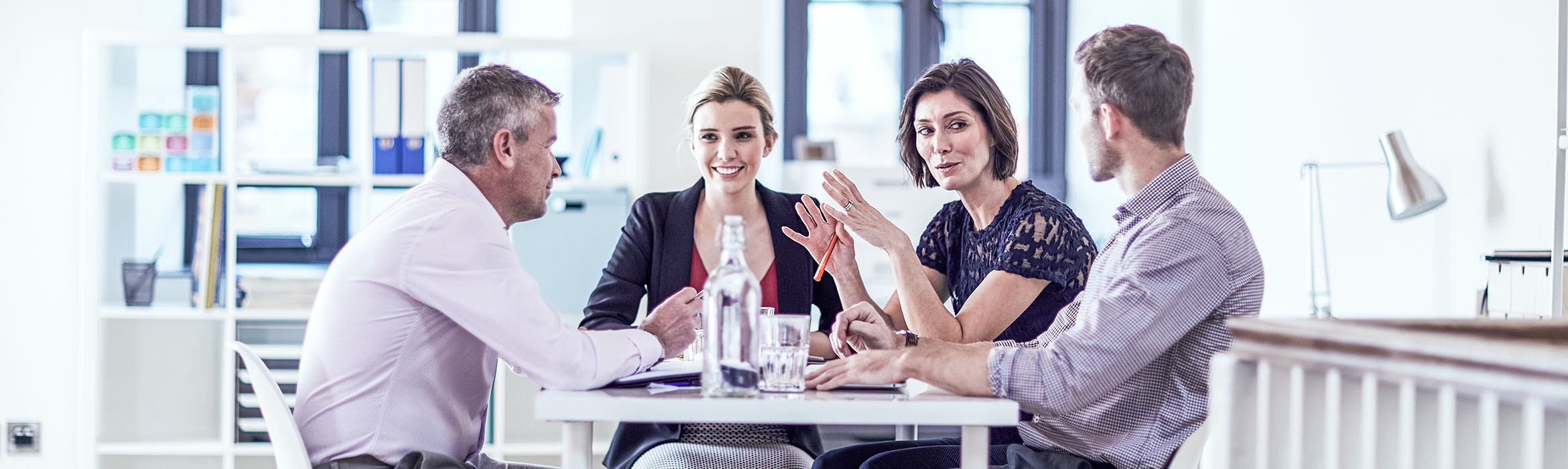 business people sat around a table in a professional environment