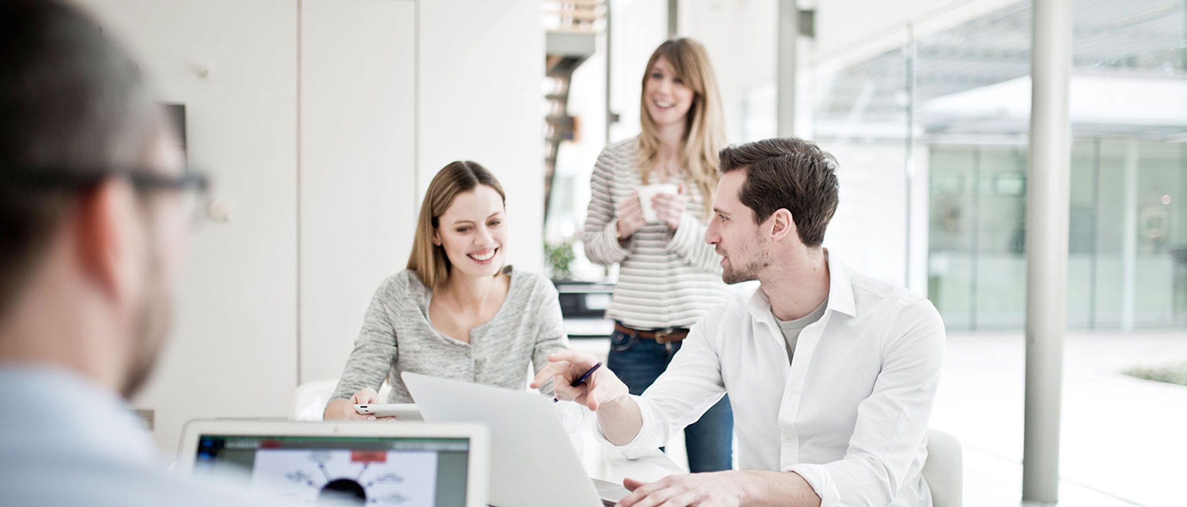 People-Discussing-Near-Laptops-Business-Solutions