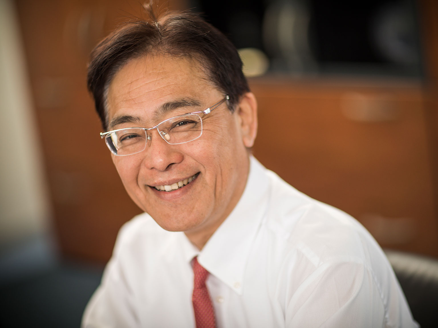 Isao Noji Managing Director of Brother International Europe sat on a chair smiling
