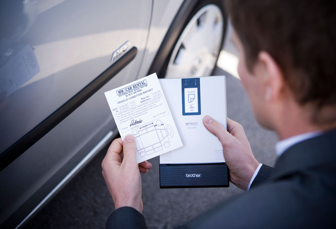 Man printing A6 document on mobile printer