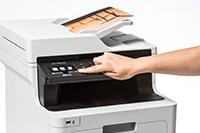 MFP colour laser with colour output and person pressing touchscreen