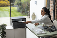 Woman taking mono output from laser printer