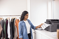 Woman in small business taking mono output from printer