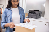 Woman viewing mono output with laser printer in background