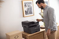 Man taking mono output from ADF of Brother printer