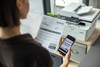 MFCB7810DW being operated by a woman using the Brother Mobile Connect app