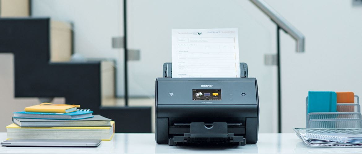 ADS-3600W desktop document scanner on shelf with notebooks