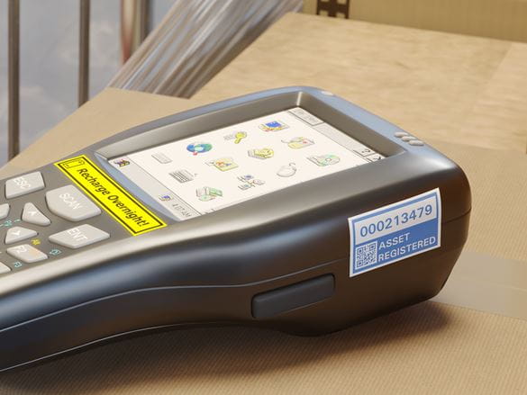 Barcode scanner with blue on white durable asset label printed on a Brother P-touch TZe laminated label