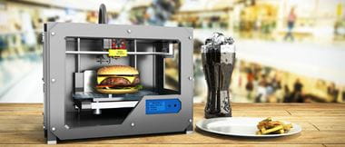 Impresora 3D imprimiendo una hamburguesa
