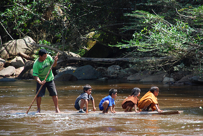 Coo Earth children and man crossing the river