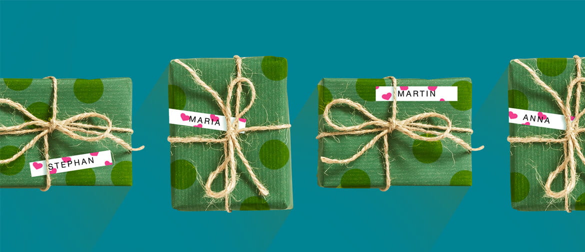 Green presents wrapped with string on a teal background