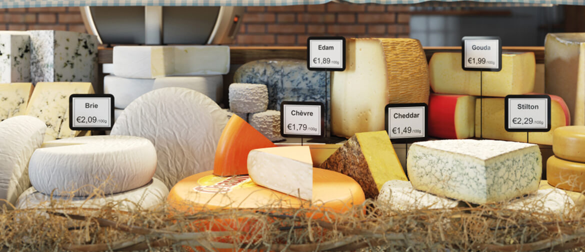 A selection of cheese on a deli counter labelled with a brother labeller