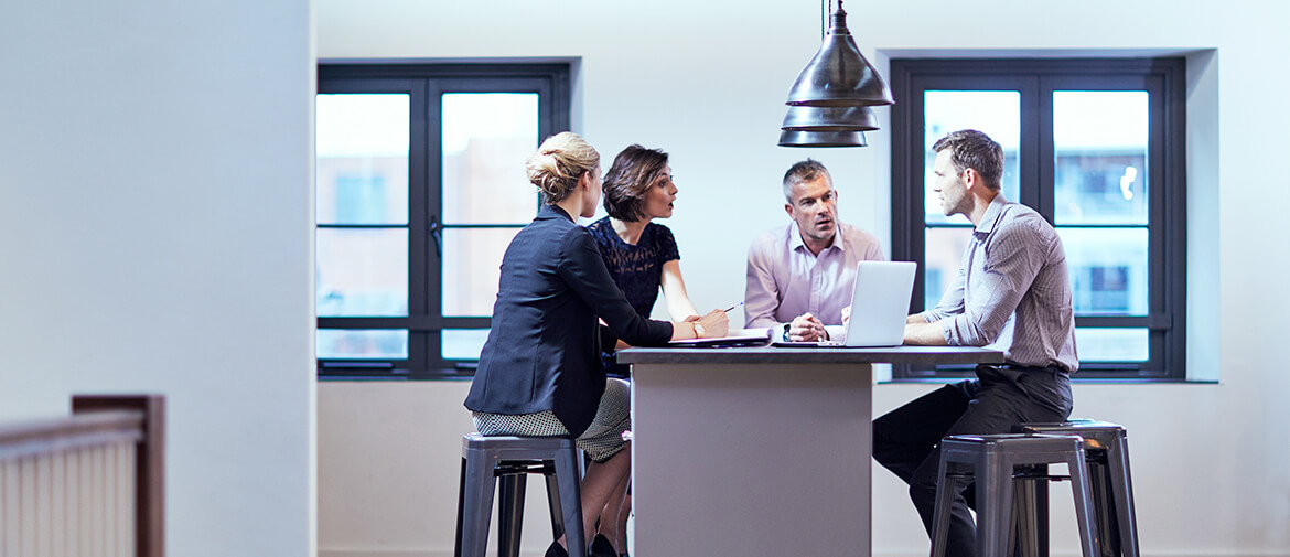 SMB employees in meeting sat around a table