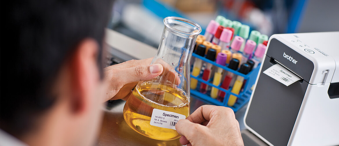 doctor labelling a sample using a brother labeller