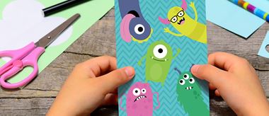 Child making a birthday card with monsters on from the creative center