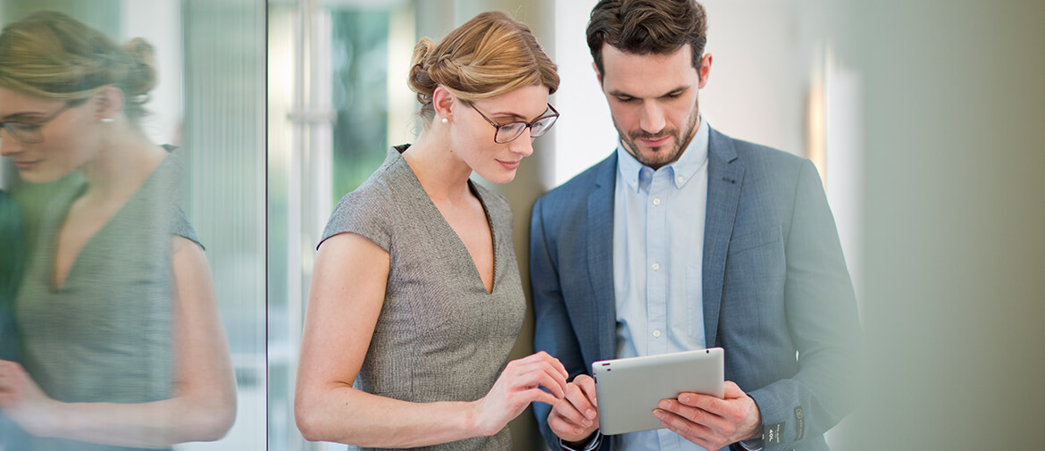 Man and woman looking at screen on tablet