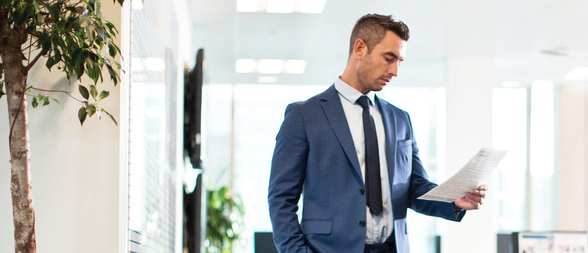 Man in office reading checklist for best printer toner