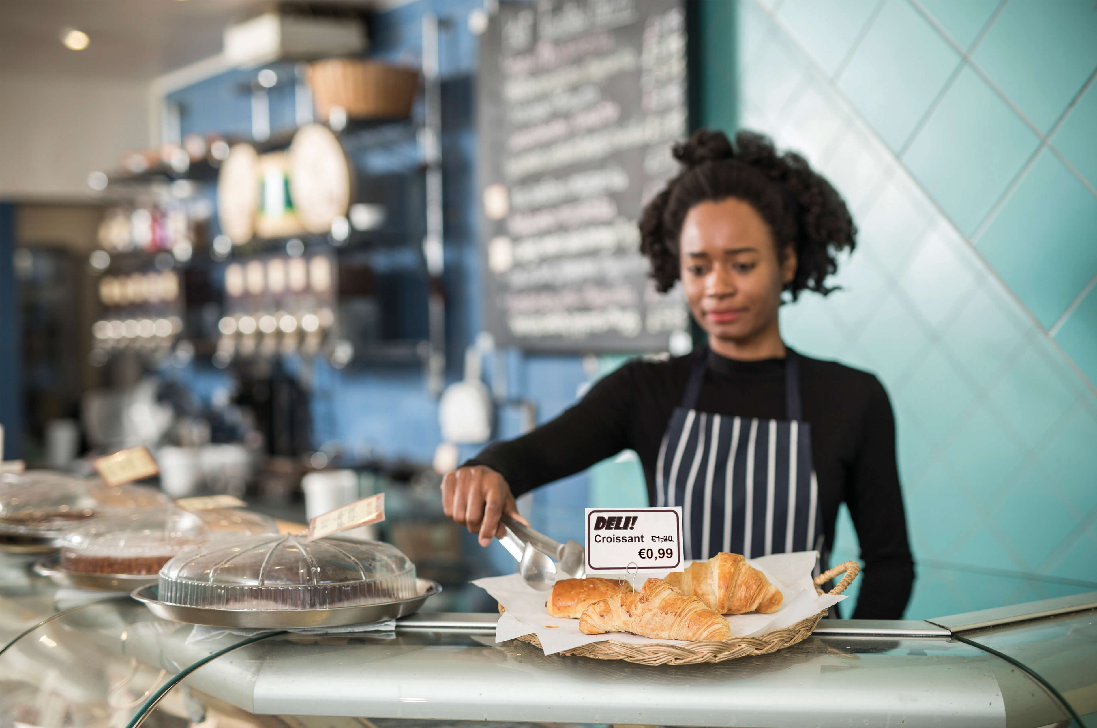 Woman in bakery labelling food products