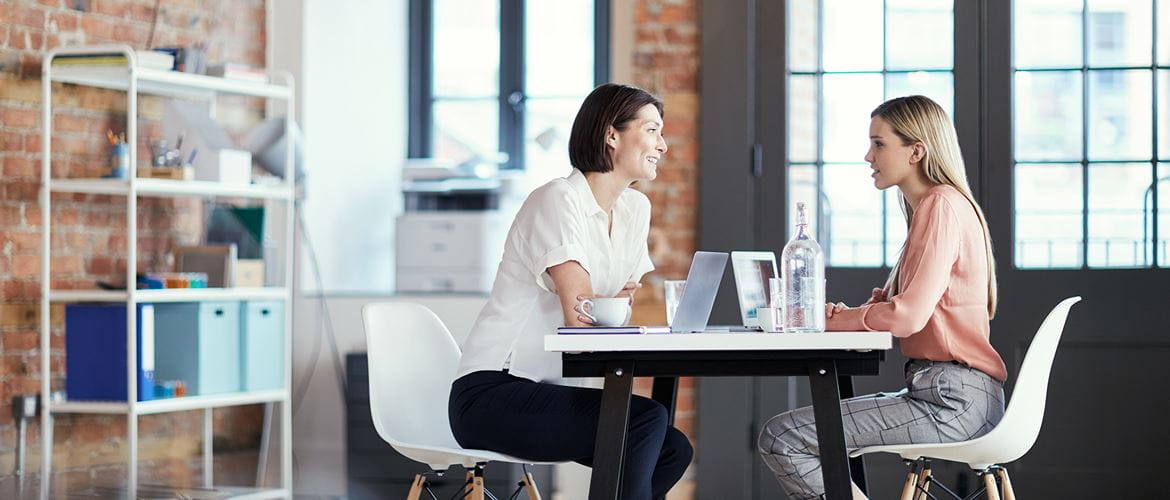 Women having a meeting talking in an office space