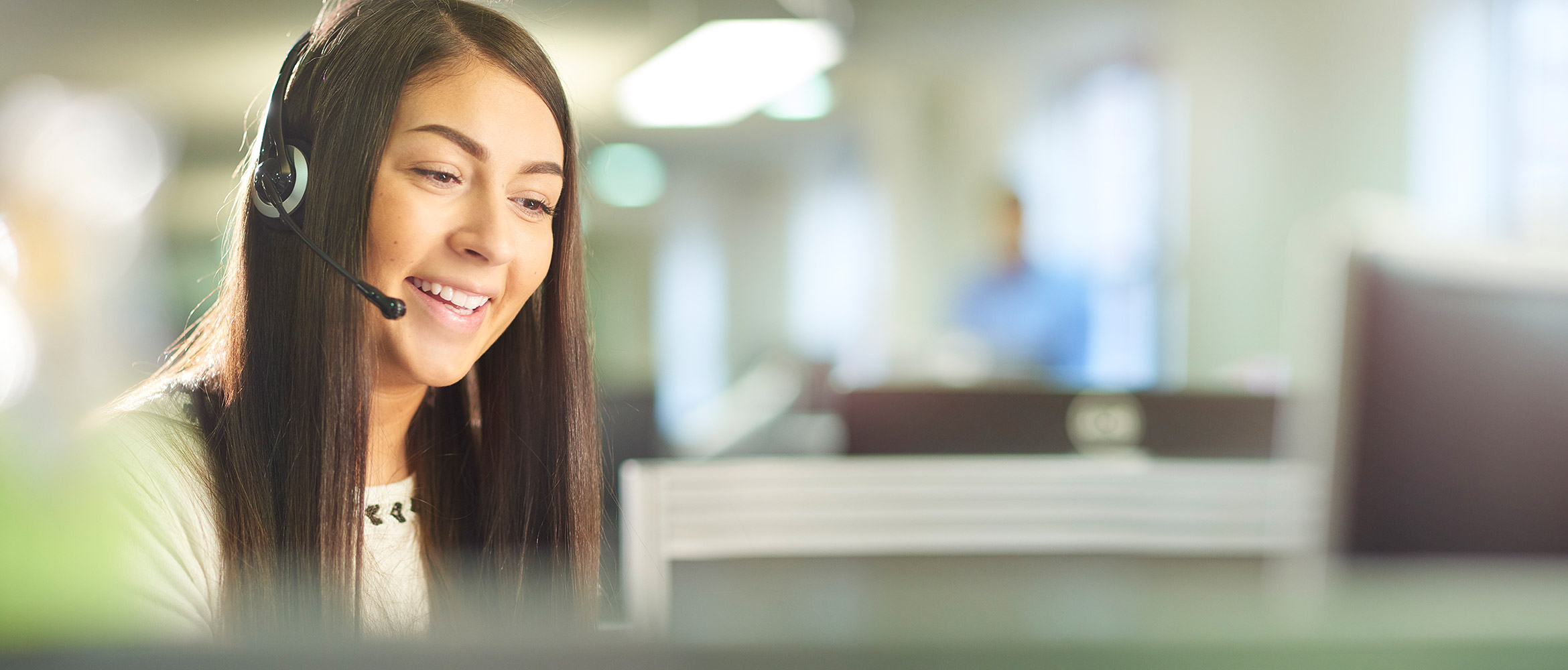 Smiling women speaking on a headset 