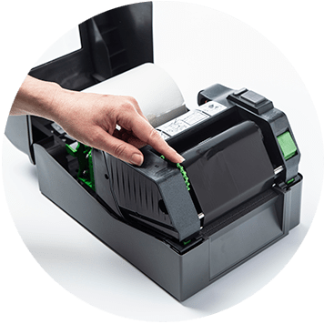 Brother TD-4T desktop label printer open with hand rolling thermal ribbon