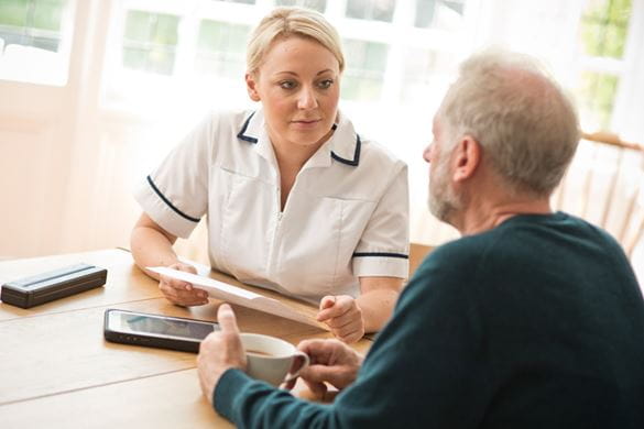 Care worker talking to patient in home