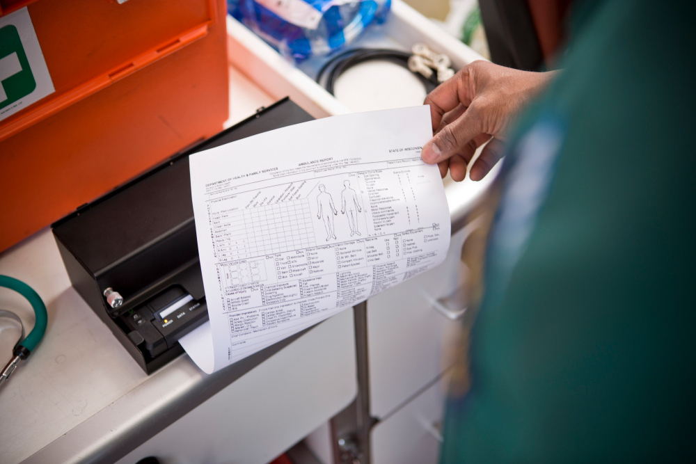 man printing A4 document in ambulance