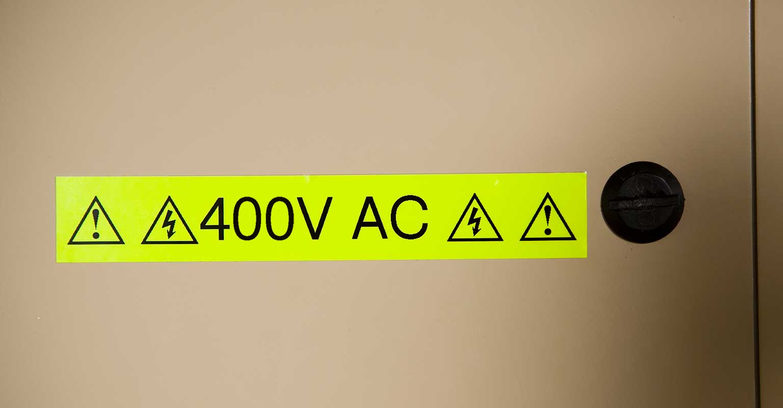 Brother fluorescent tape warning sign showing 400 volts AC