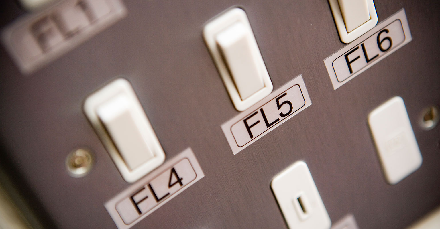 Light switches identified with a Brother black on silver tape