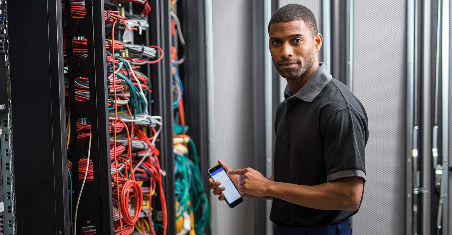 Network technician using Brother iLink&Label app on his smartphone