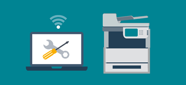 Printer next to laptop with spanner and screw driver and wifi icon on top