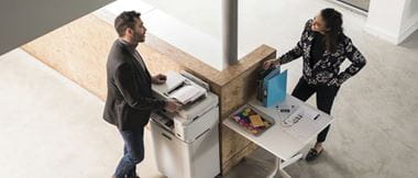 Male and female talking whilst using a Brother printer