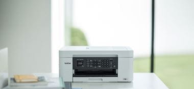 Brother MFC-J497DW inkjet printer on desk in home office