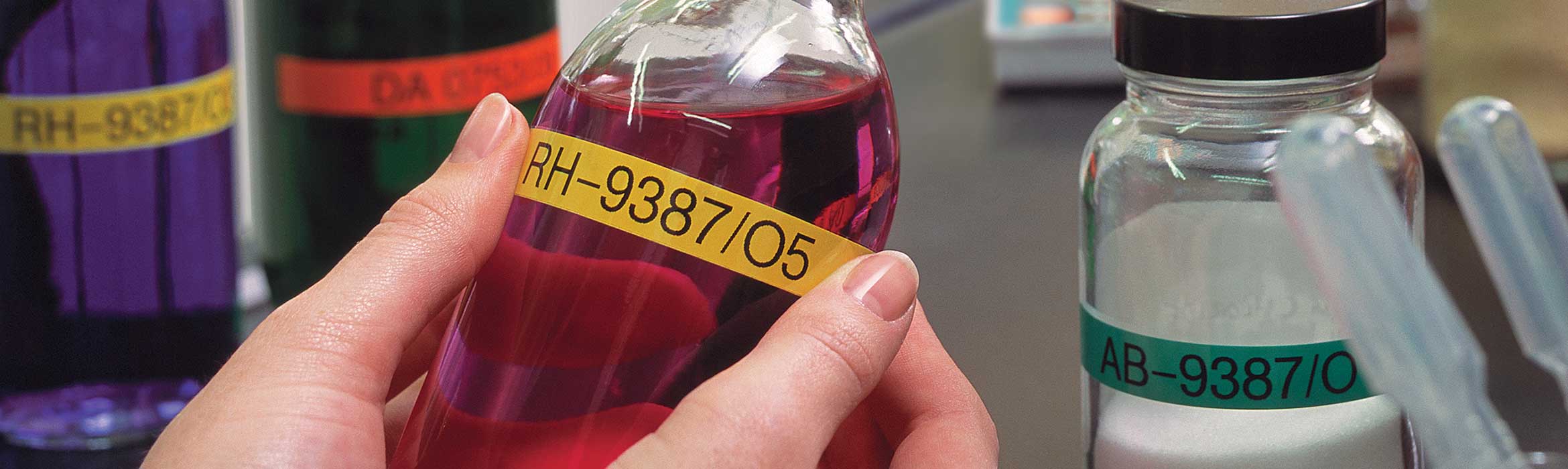 Bottles containing chemicals being labelled with Brother P-touch TZe labels