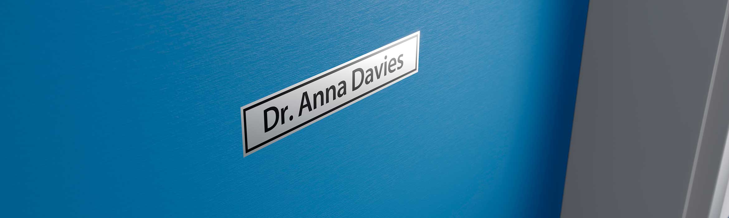 Brother black on silver label printed with name of doctor, and stuck on their door