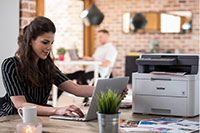 Woman sat with printer on desk