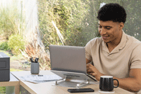 Man sat at desk working on a laptop