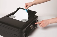 Person feeding document into Brother multifunction printer