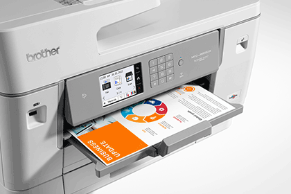 Close-up of printer printing colour document