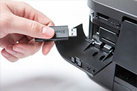 Black printer with hand inserting USB - DCP-J772DW