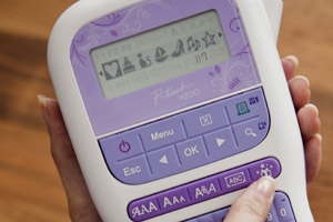 Close-up of symbols being displayed on the LCD screen of a P-touch handheld label printer