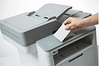 Close up of 3 in 1 printer, with hand holding ID card