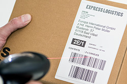 QL-1110NWB label affixed to a parcel being scanned
