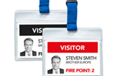 Black and red visitor badges printed on a Brother QL-820NWBVM badge printer
