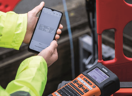 Engineer using the PT-E550W Pro Label Tool app on a fibre installation project