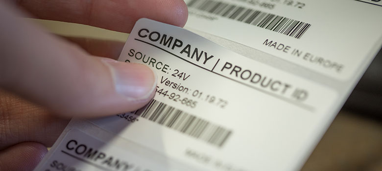 Close up of product label being peeled