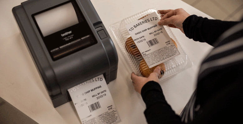TD-4T-labelprinter og label, der bliver sat på en pakke med småkager