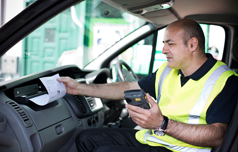 Man in high visibility vest inside a vehicle printing an A4 sheet of paper from Brother PJ printer